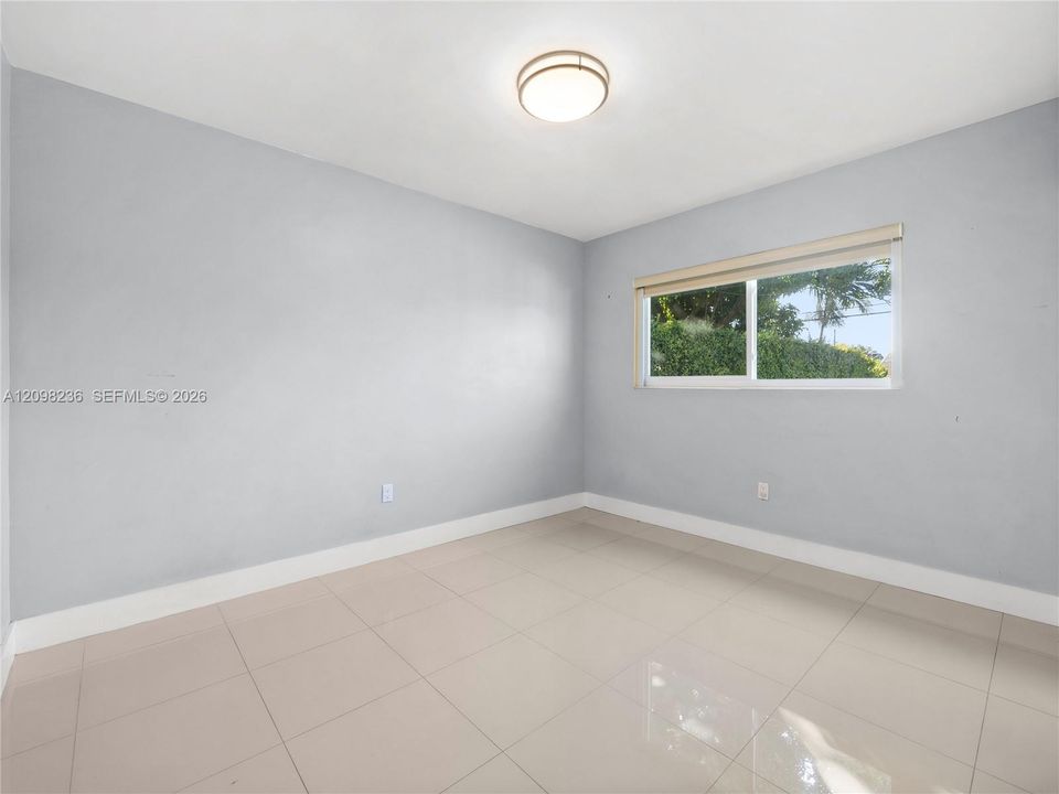 Bright bedroom with natural light and a clean, neutral interior.