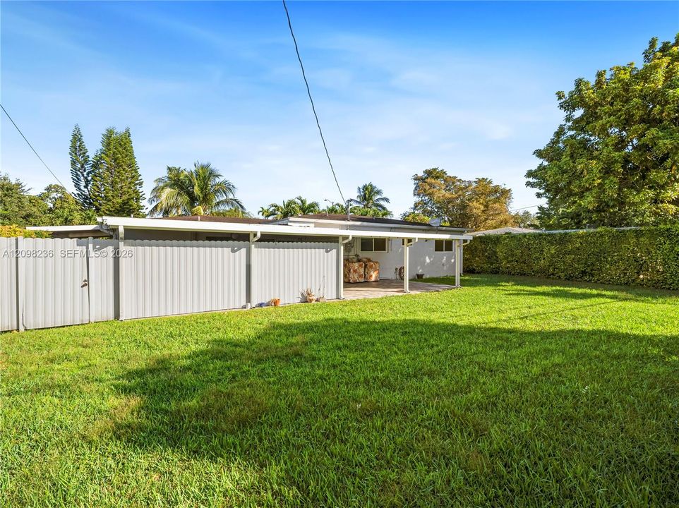 Large fenced backyard with plenty of open lawn and private outdoor space.
