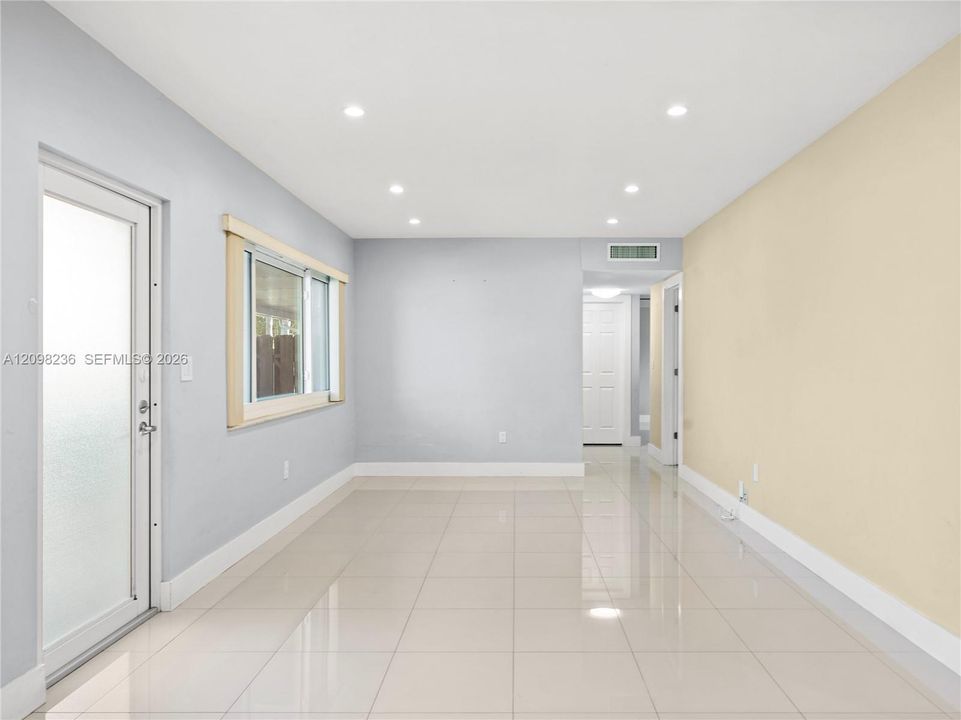 Living room highlighting the bright, spacious interior and recessed lighting.