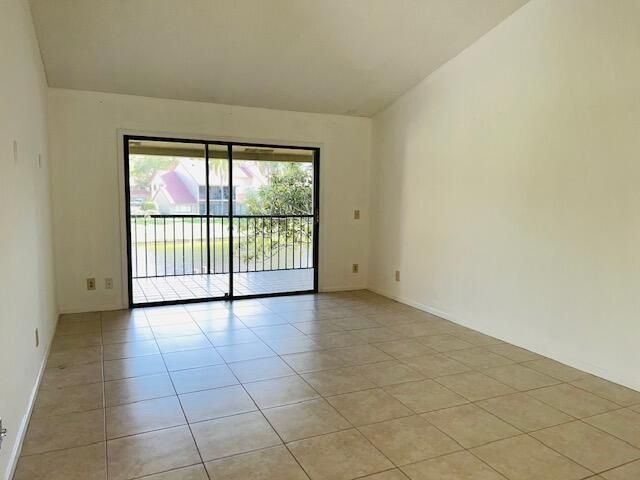 LIVING ROOM LEADS TO SCREENED BALCONY
