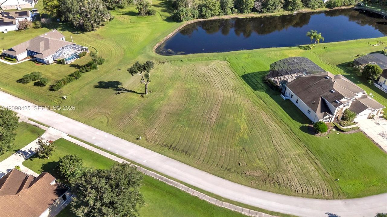 Vacant lot featuring grassy topography, corner positioning, and water frontage