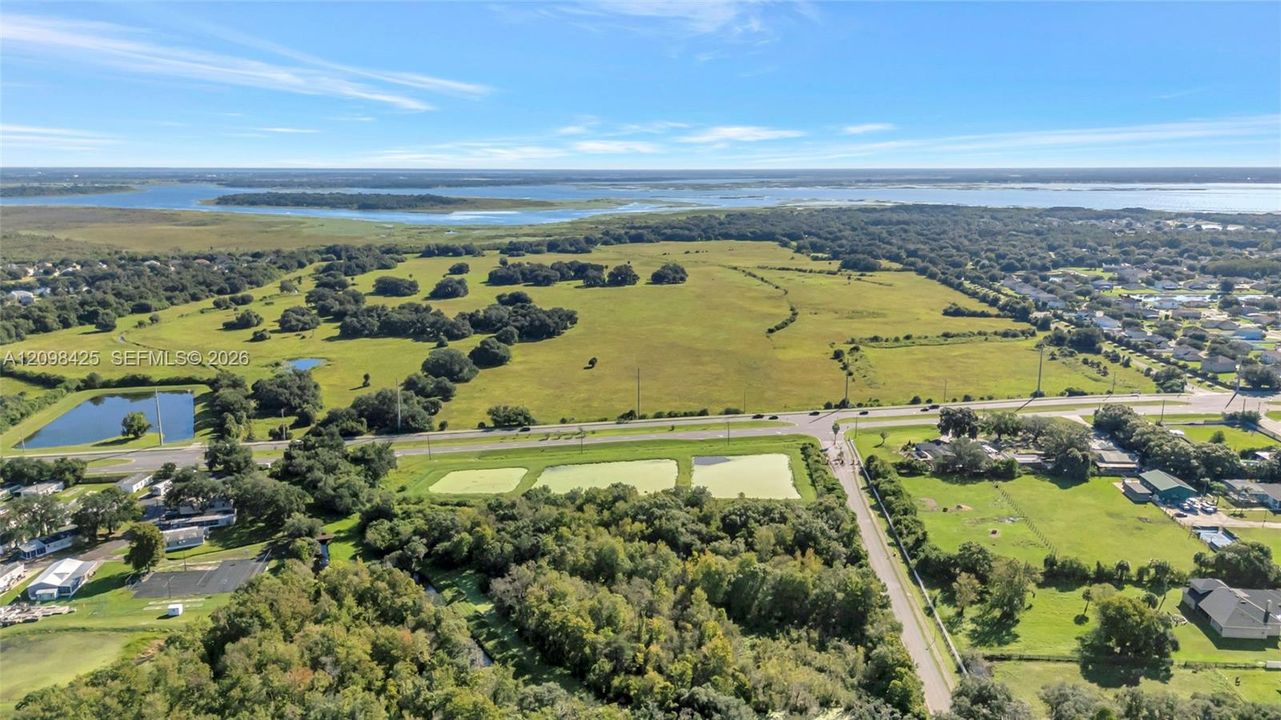 Expansive acreage featuring mature trees, multiple water features, and open green space