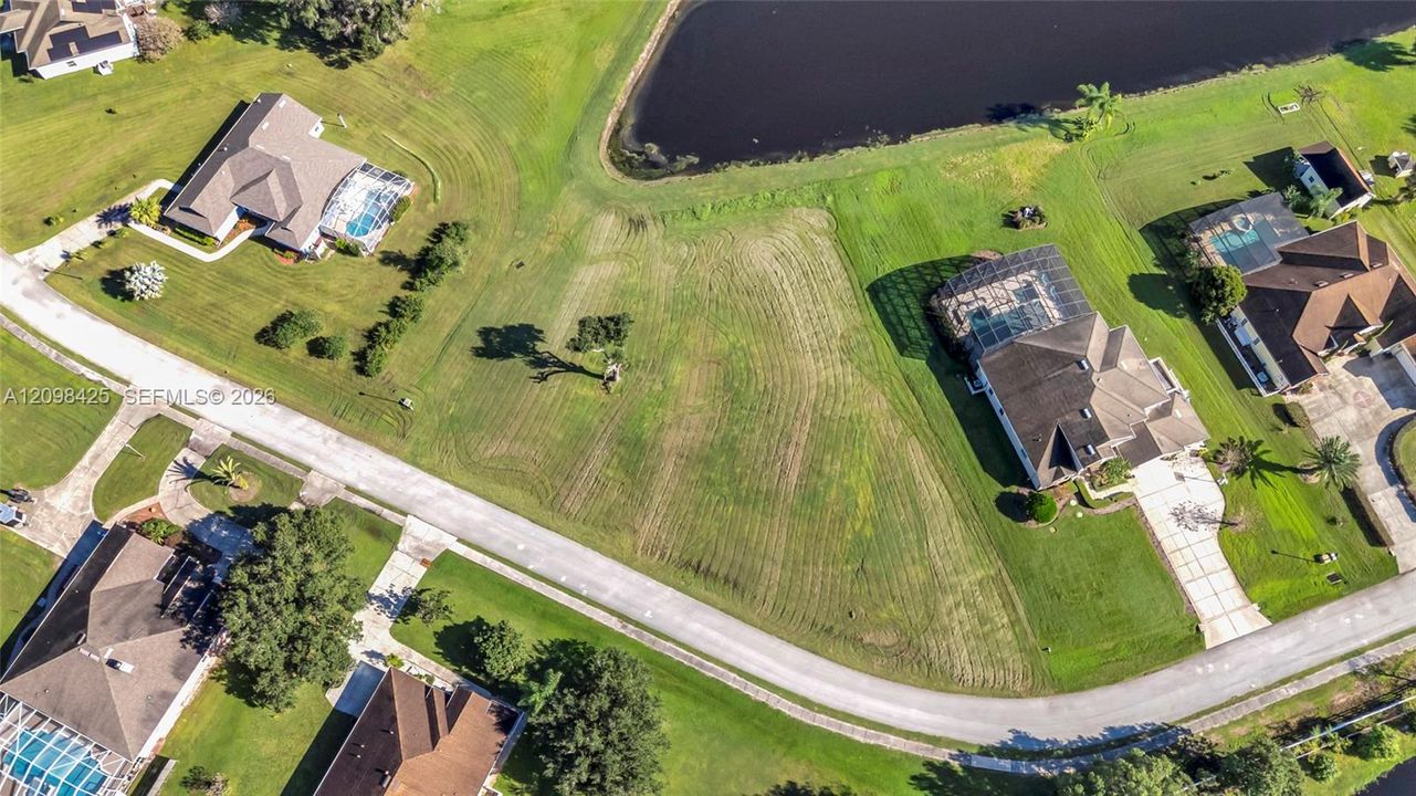 Vacant residential lot featuring direct water frontage and manicured lawn