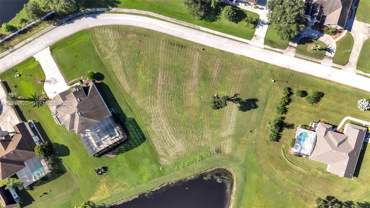 Corner lot featuring expansive grass area and waterfront frontage