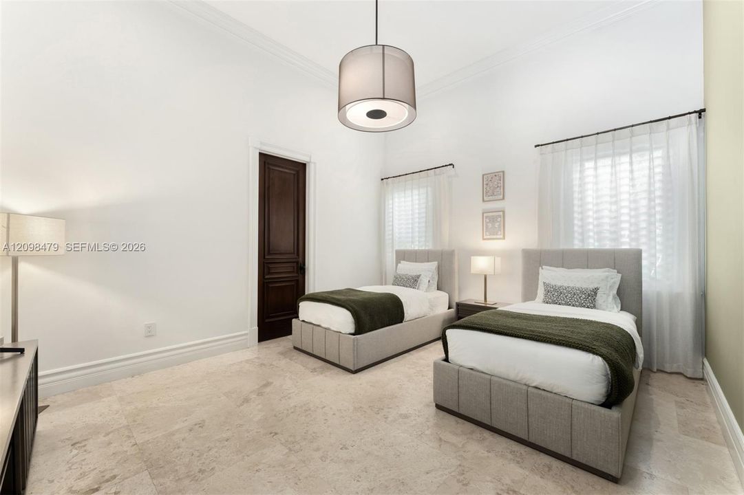 Recessed lighting and a drum pendant fixture illuminate the space