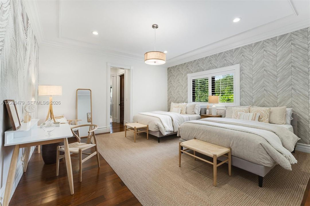 Wood-finish flooring, recessed lighting, crown molding, a window with plantation shutters, and a drum pendant light fixture
