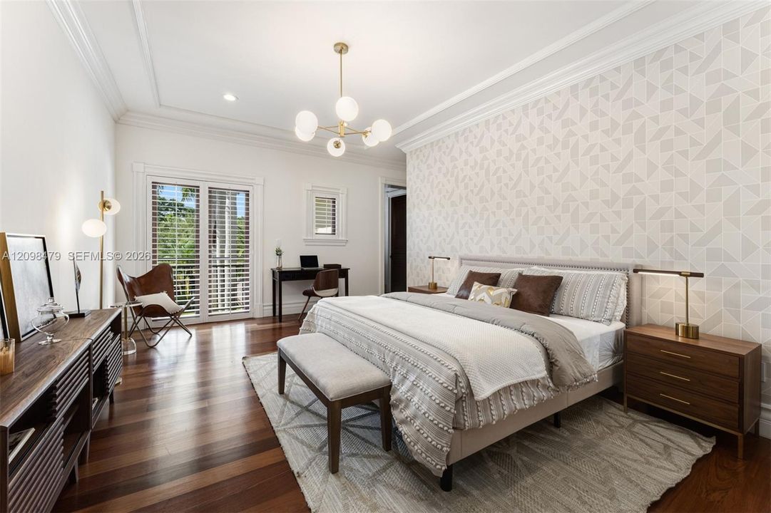 Hardwood flooring, crown molding, double-paned glass sliding doors, recessed lighting, and a modern light fixture
