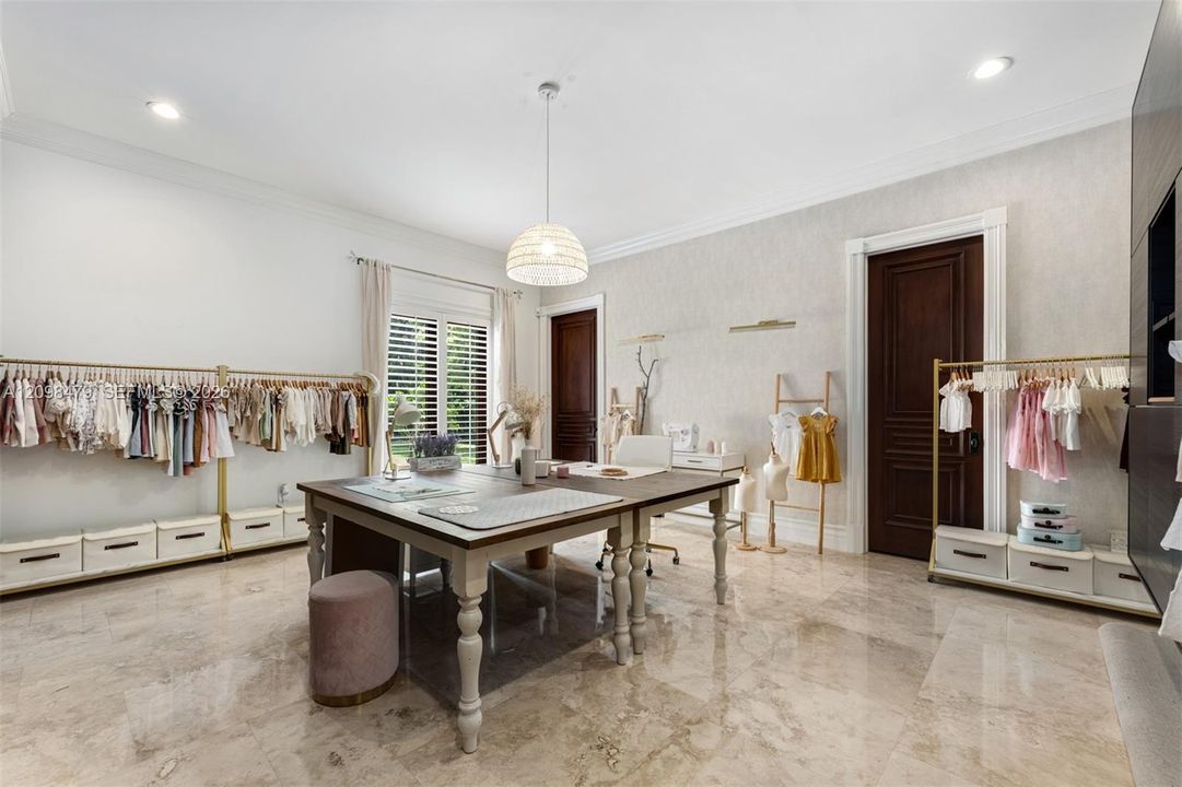 Recessed lighting, chandelier, wood-finish doors, window with plantation shutters, and polished stone flooring