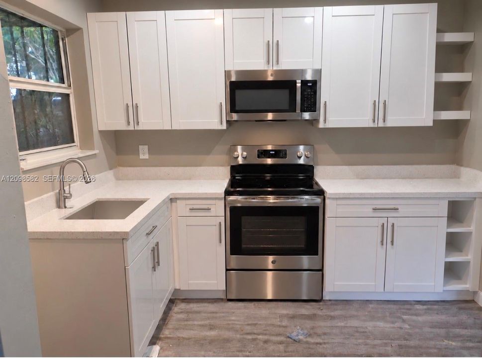 Kitchen featuring white cabinetry VIRTUAL w/ appliances countertops, stainless steel appliances, open shelving, and wood-finish flooring