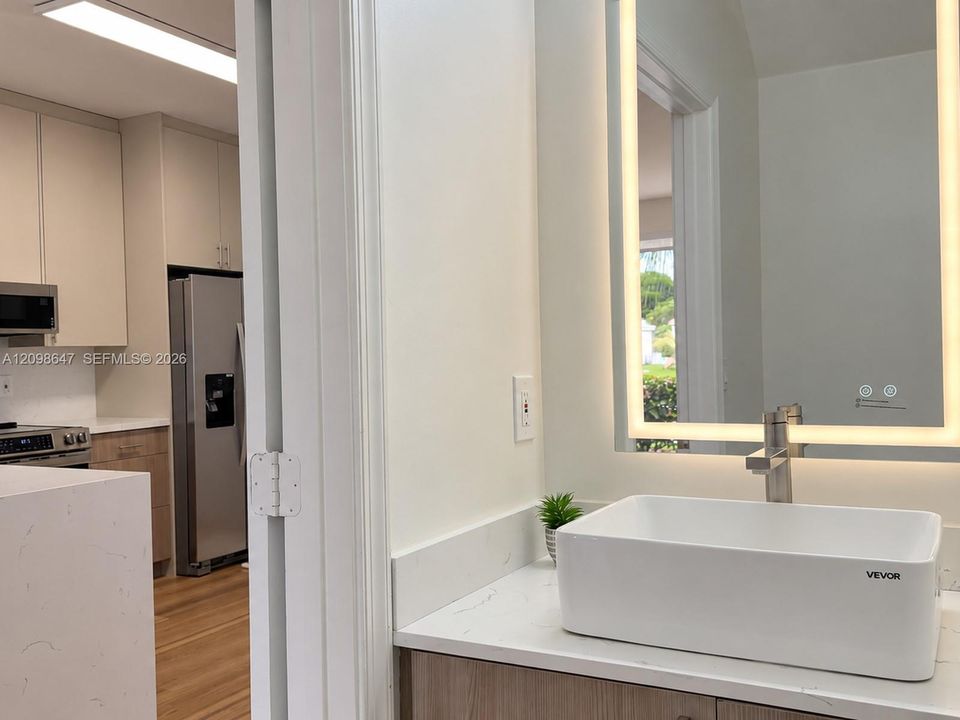 Clean half bathroom with modern vanity.