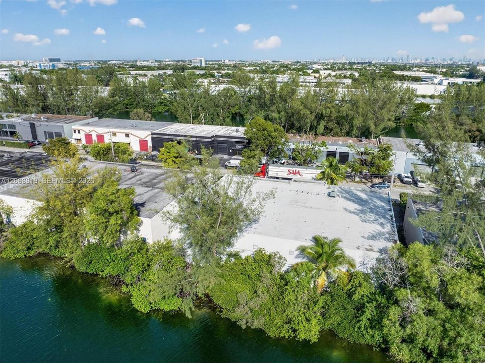 Building is one with 3 red garage doors to the left