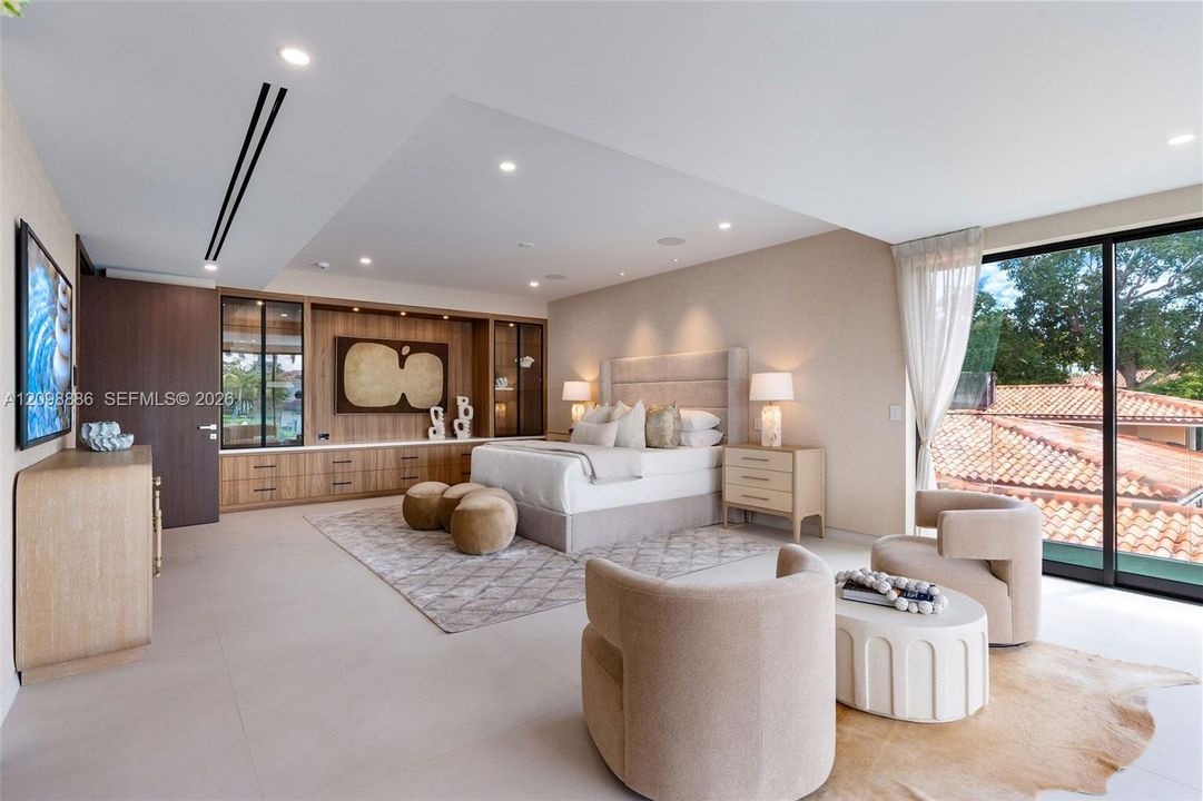 Built-in wood-finish cabinetry, recessed ceiling lighting, large-format tile flooring, and floor-to-ceiling glass sliding doors