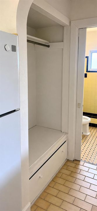 Bright Hallway with Arched Closet and Ba