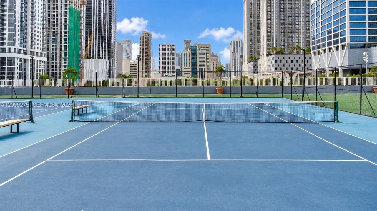 Tennis courts surrounded by Miami’s impressive downtown skyline, offering residents a scenic outdoor space for recreation and an active lifestyle.
