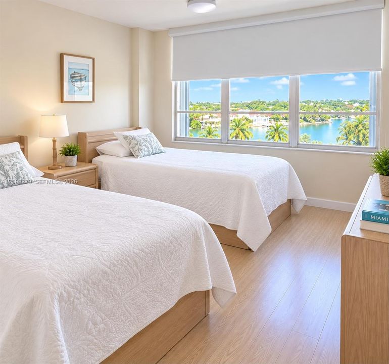 Neutral-toned interior featuring wood-finish flooring, a large triple-pane window with a retractable roller shade, and panoramic water and landscape scenery