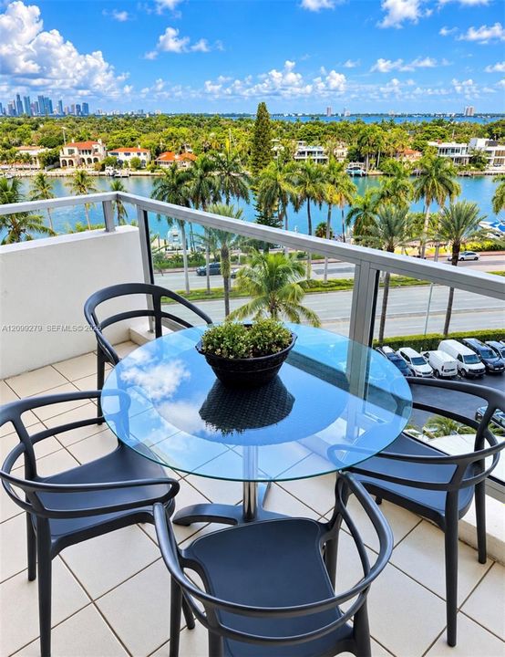 Private balcony featuring large-format tile flooring and metal-framed glass railings