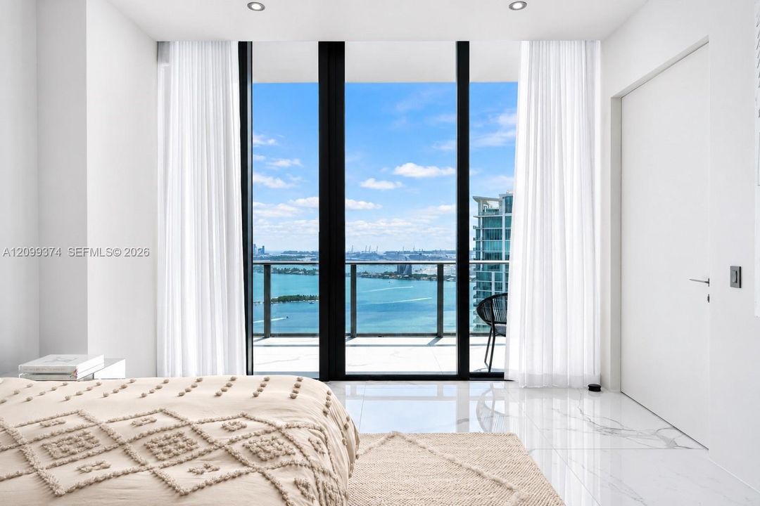 Bedroom opening toward private outdoor and water views