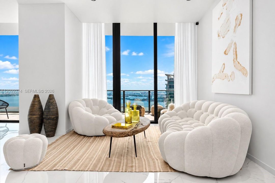 Sitting room framed by floor-to-ceiling water views