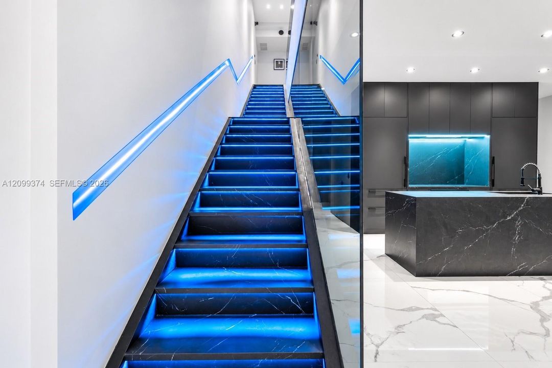 Custom staircase with integrated blue LED lighting
