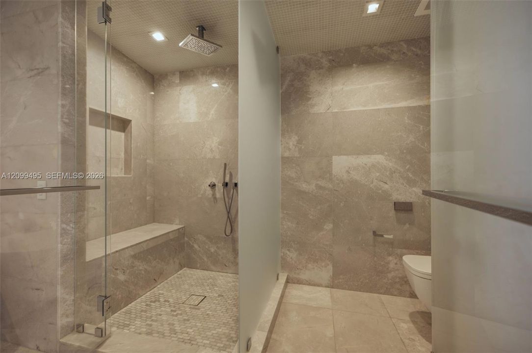 Master Bathroom features a book-matched marble wall, marble flooring along with European Dornbracht® fixtures.