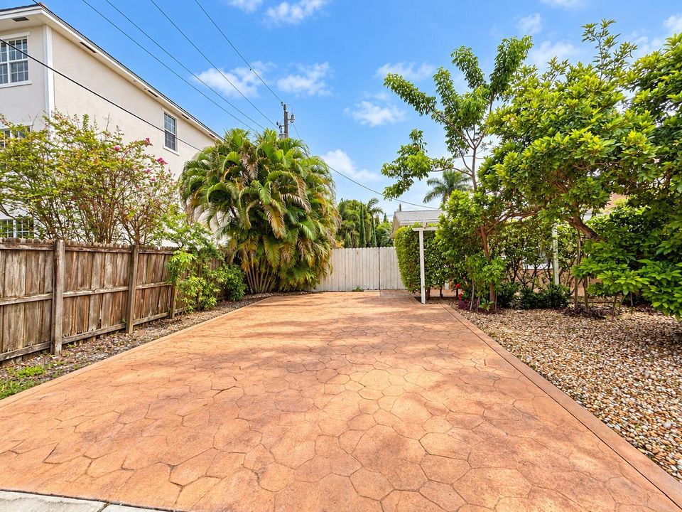 Sunlit Stamped Concrete Garden Driveway
