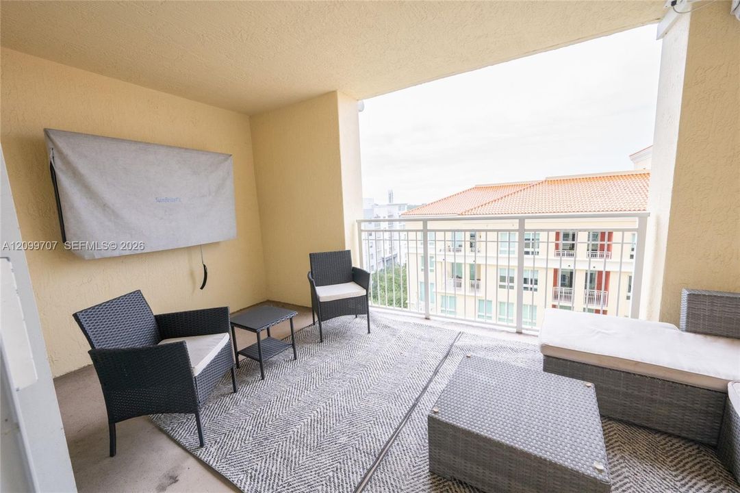 large balcony off both the living area and the bedroom