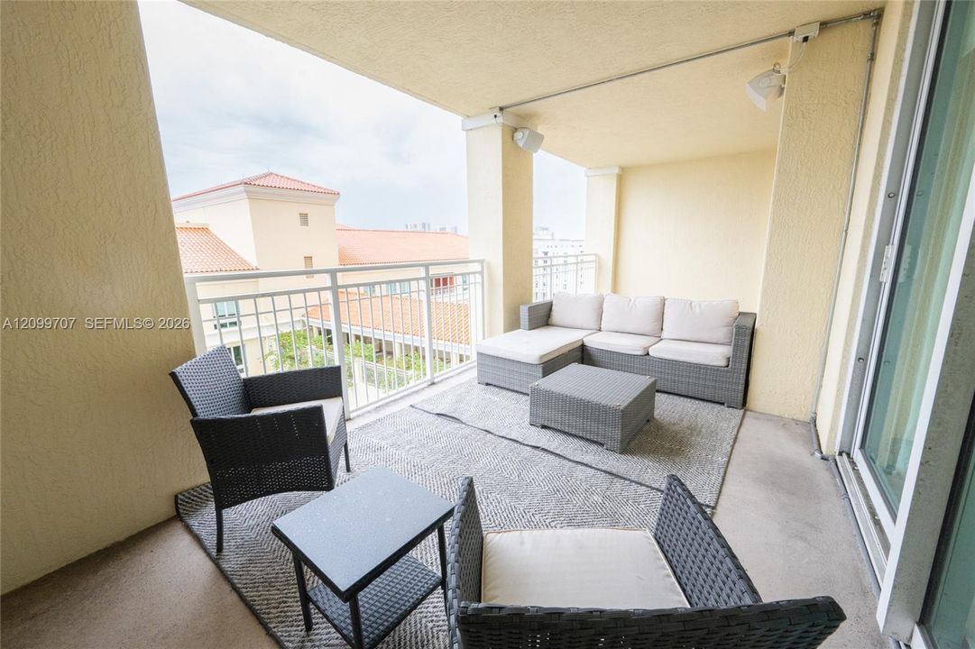 large balcony off both the living area and the bedroom
