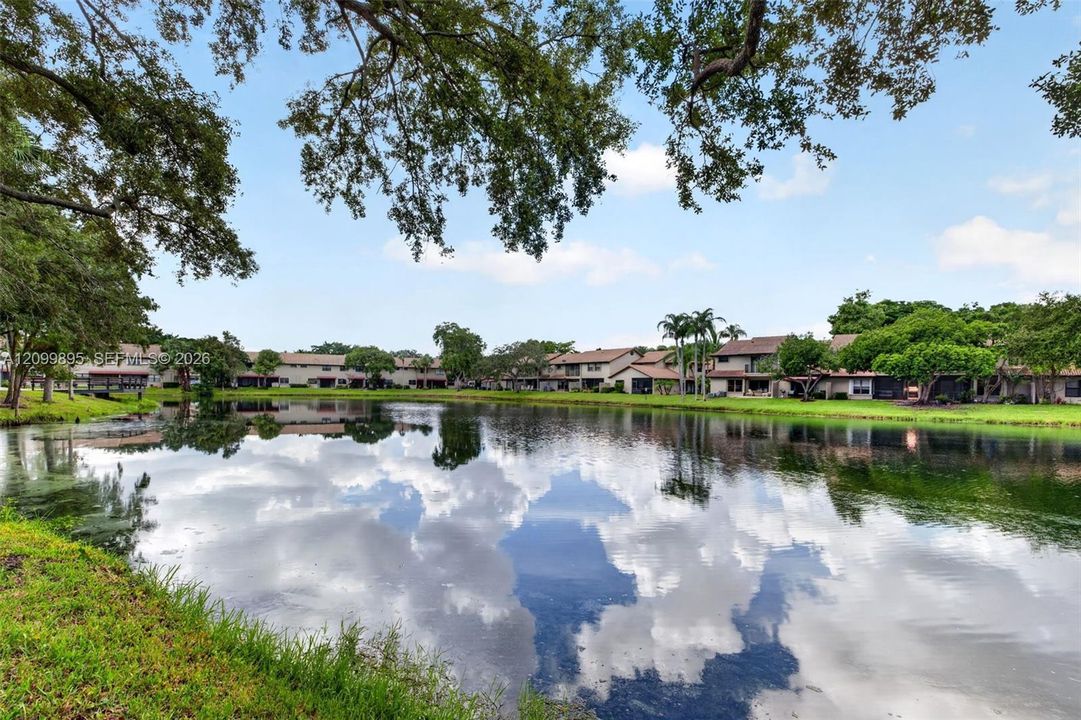 Serene lake views create a peaceful backdrop from the home's outdoor living space.