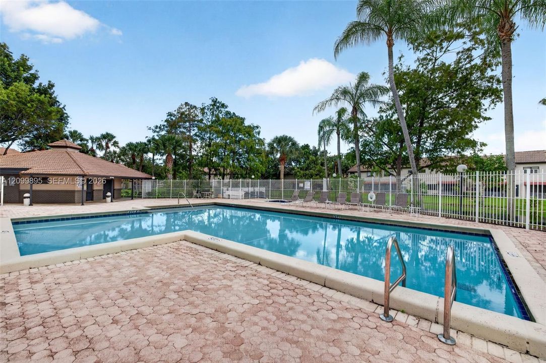 Community pool offers a relaxing setting for swimming and outdoor recreation.