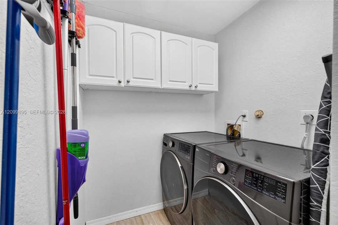 Convenient laundry room equipped for everyday household needs.