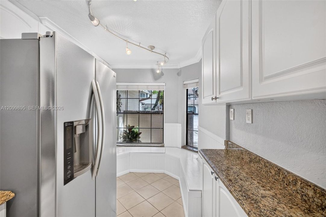 Well-equipped kitchen featuring ample cabinetry, a pantry and a convenient breakfast area.