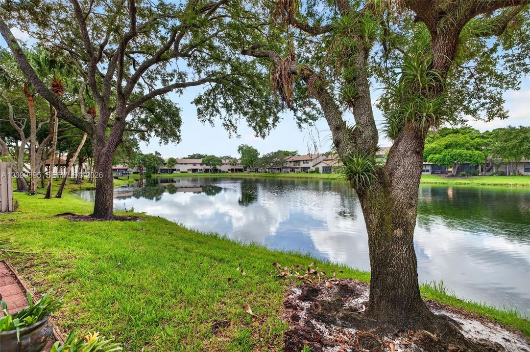 Serene lake views create a peaceful backdrop from the home's outdoor living space.