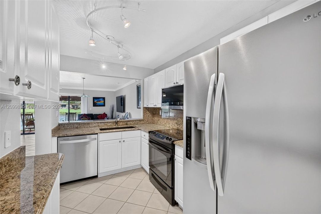 Well-equipped kitchen featuring ample cabinetry, a pantry and a convenient breakfast area.