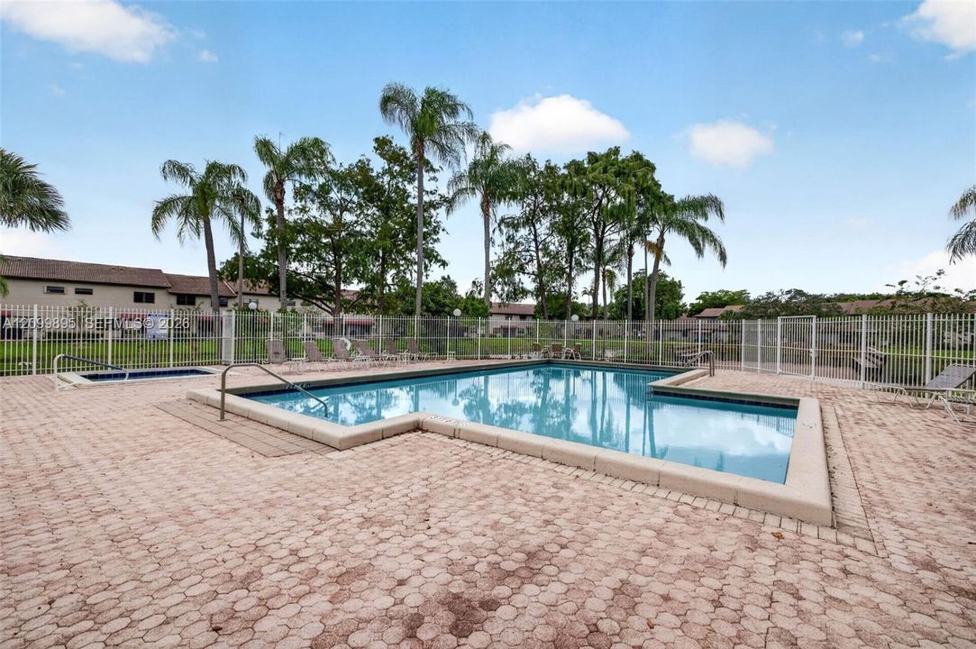 Community pool offers a relaxing setting for swimming and outdoor recreation.