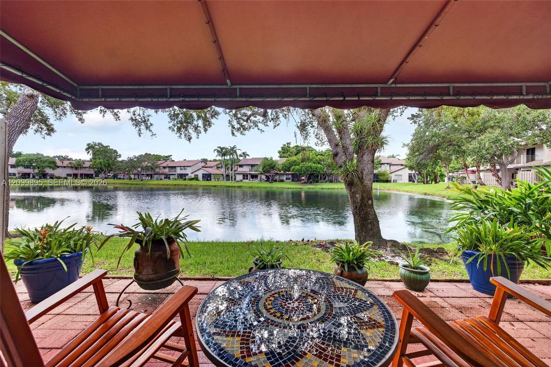 Serene lake views create a peaceful backdrop from the home's outdoor living space.