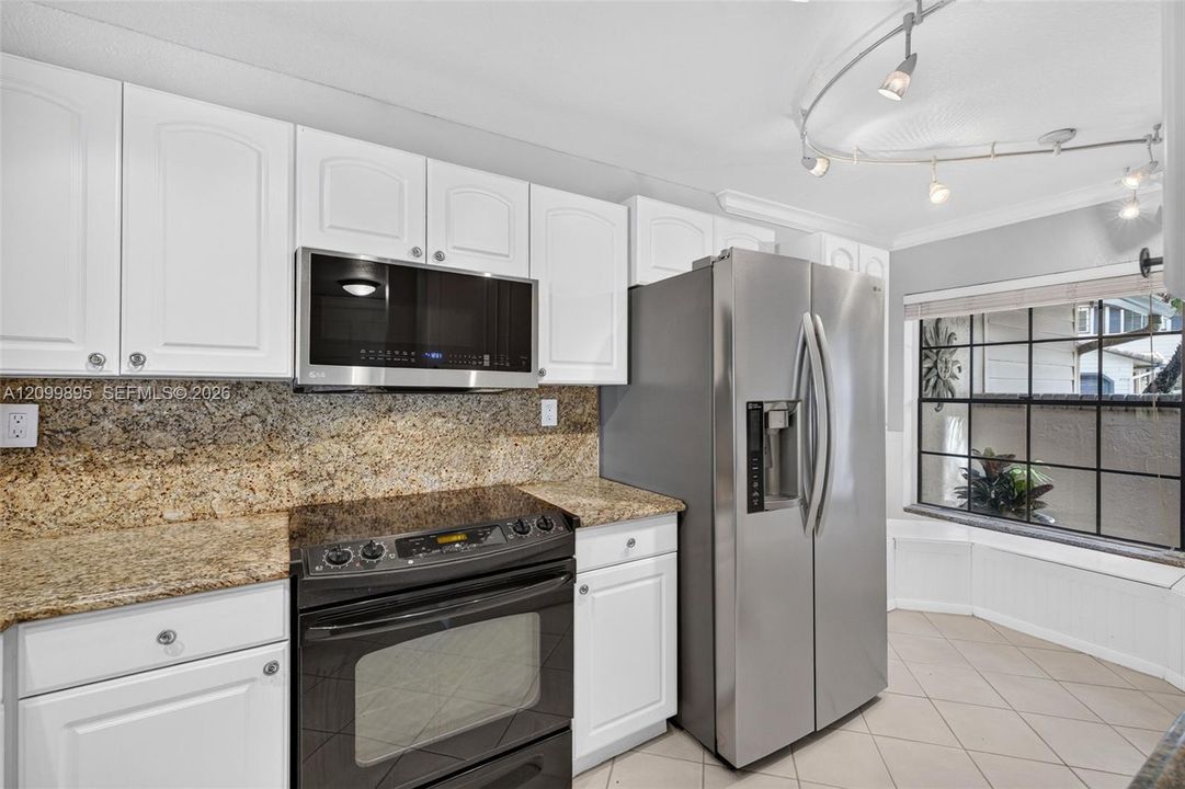 Well-equipped kitchen featuring ample cabinetry, a pantry and a convenient breakfast area.