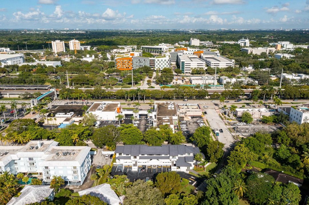In this picture, if you look a little to the left and you will see the "Pedestrian Cross Over Bridge" ( SEE THE AQUA BLUE ROOF ) taking everyone safely over the major Highway! At the end of the "Pedestrian Cross Over Bridge is the University Metro-Rail Station and of course beyond that is the whole University of Miami's main campus!