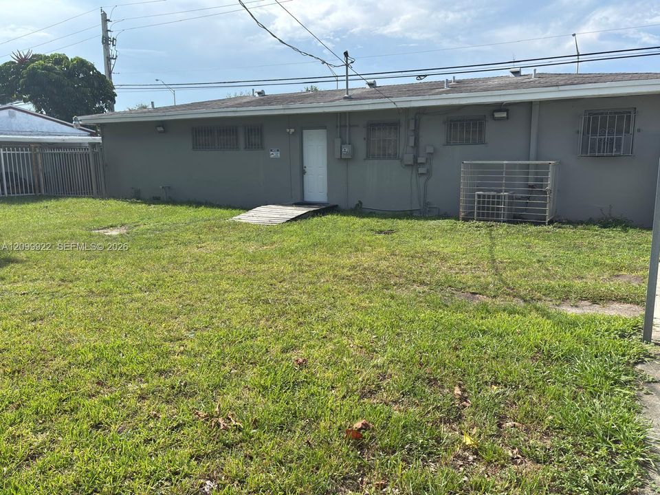 Rear view of the medical office showing the back exterior and additional yard/parking area.