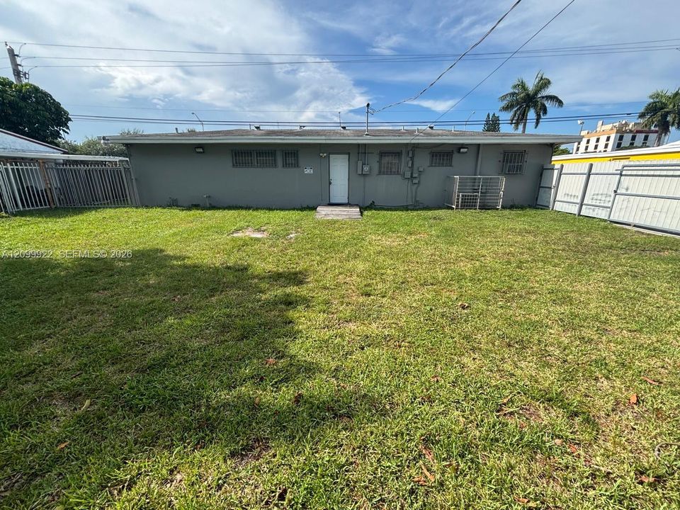 1. Back view of the structure showing rear access area and fenced grounds.