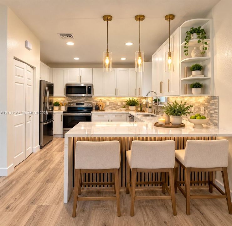 Kitchen featuring white shaker-style cabinetry, a stone-patterned waterfall edge island, wood-finish flooring, textured tile backsplash, and three brass pendant lights