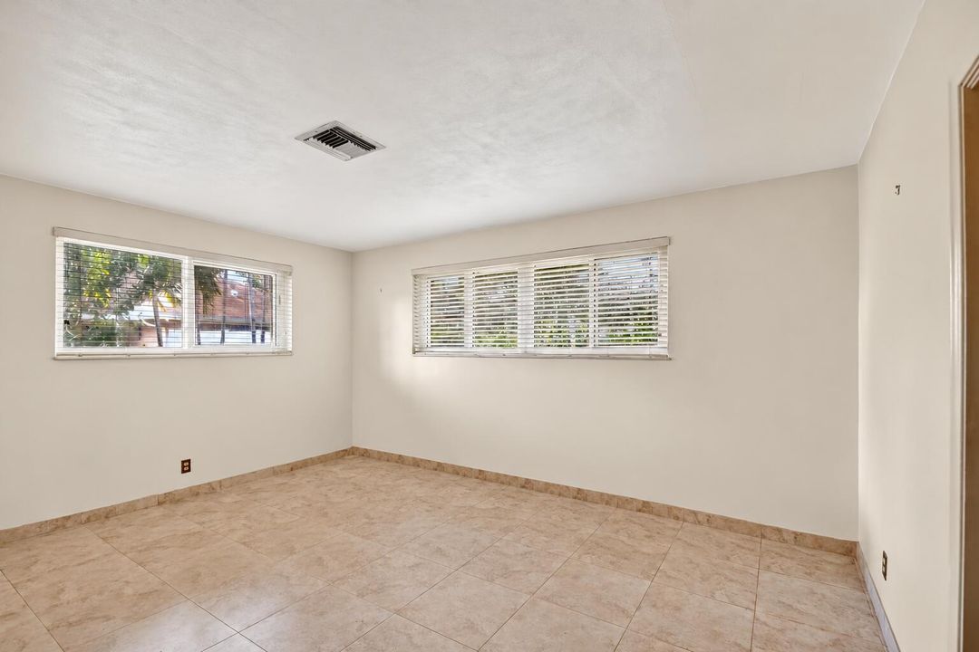Empty Sunlit Room with Horizontal Blinds