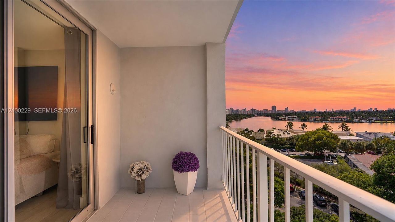 Covered balcony featuring a metal railing, neutral floor surfacing, and sliding glass entry