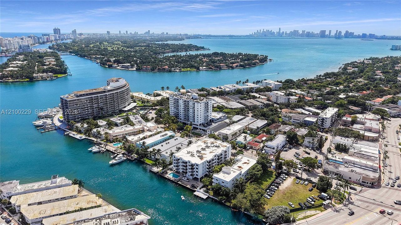 Aerial perspective featuring expansive waterfront positioning, deep-water access, multiple boat slips, and panoramic skyline scenery