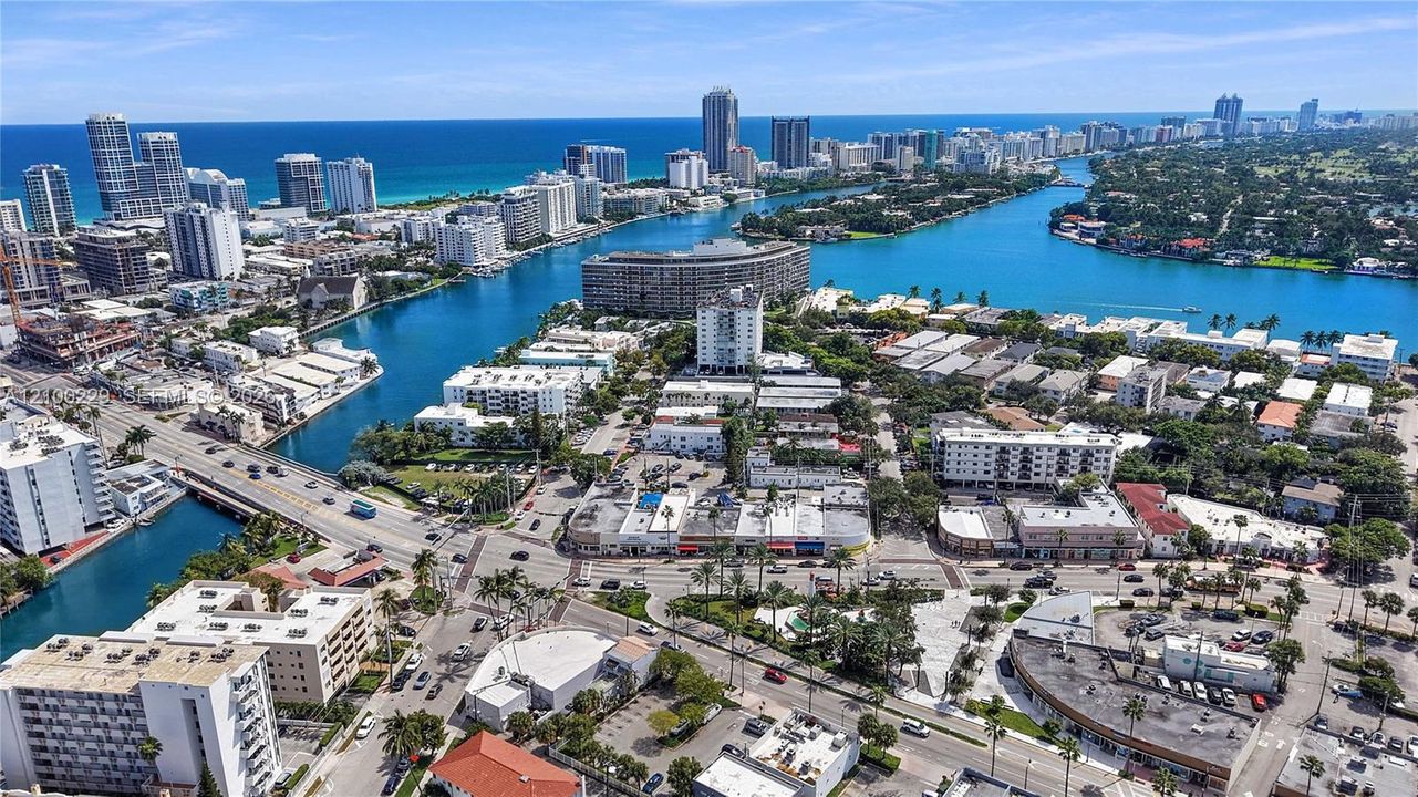 Aerial perspective of coastal urban environment featuring waterway access, mid-rise developments, high-density infrastructure, and proximity to the oceanfront