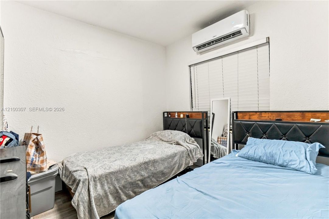 Wall-mounted mini-split HVAC unit and horizontal slat blinds