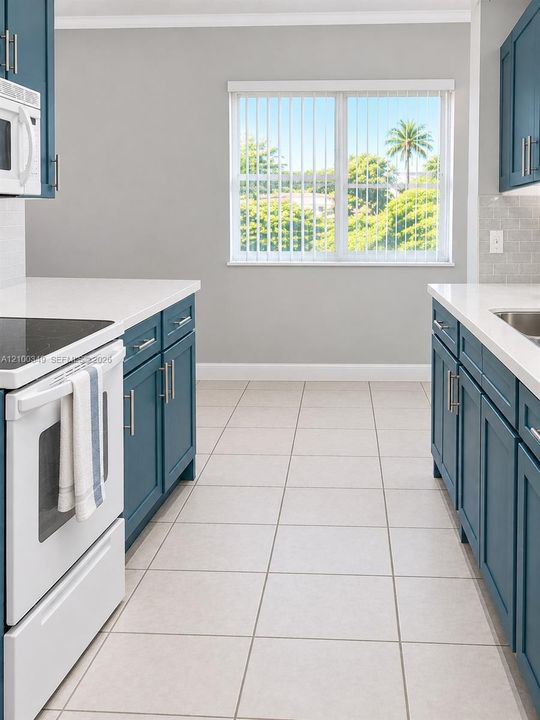 Kitchen featuring blue shaker-style cabinetry, white solid-surface countertops, neutral tile flooring, a subway tile backsplash, and a window with exterior greenery