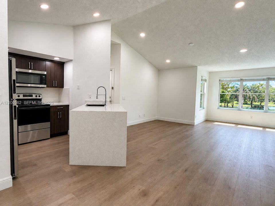 Modern open-concept kitchen featuring clean lines, updated finishes, recessed lighting, and seamless flow into the living area.