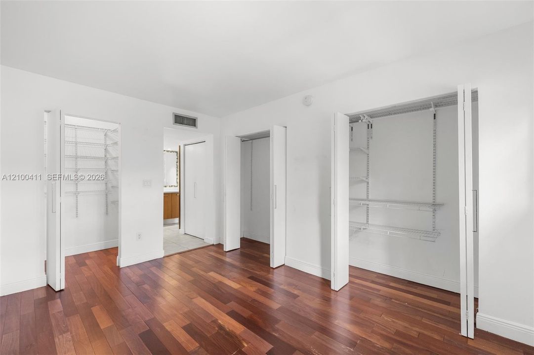 Wood-finish flooring, two sets of bi-fold closet doors, and integrated wire shelving storage