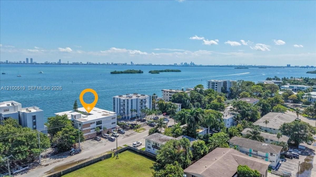 Aerial perspective featuring direct water frontage, expansive horizon, and coastal setting
