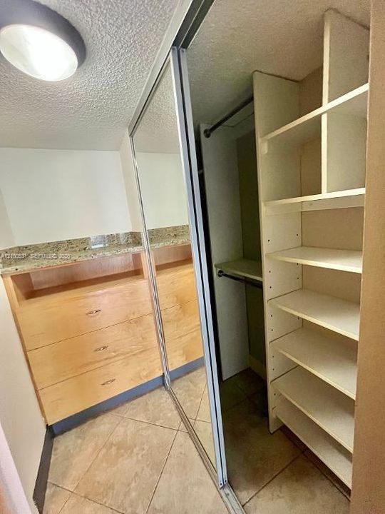 primary bedroom has multiple custom closets throughout